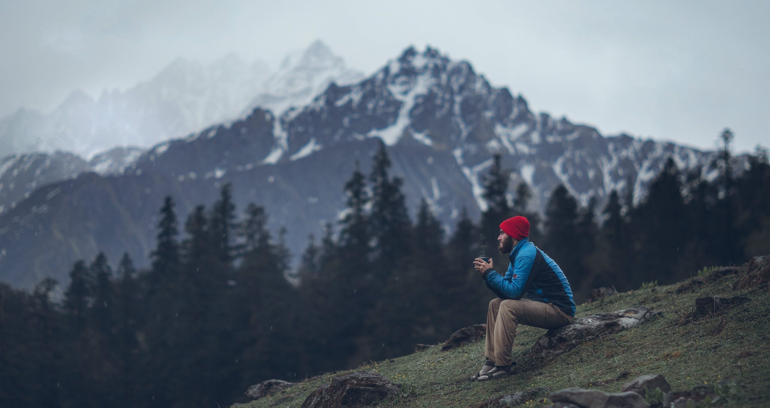 A man sitting on mountain side